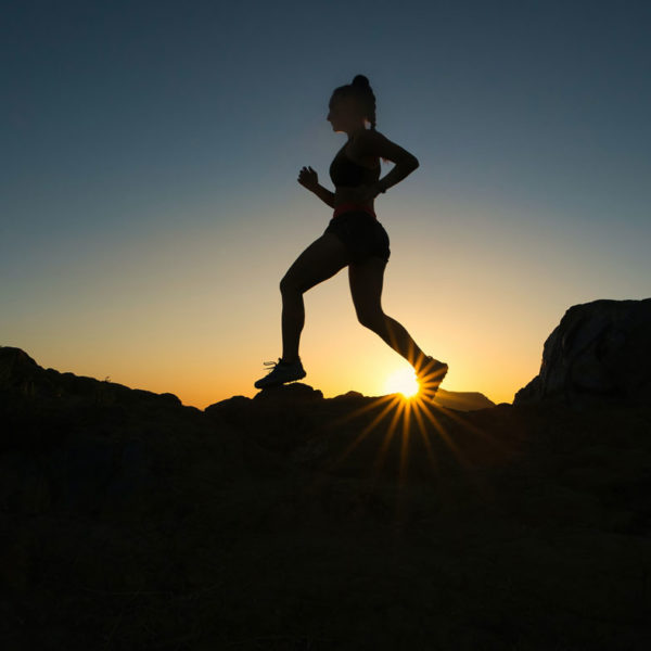 woman jogging in sunset