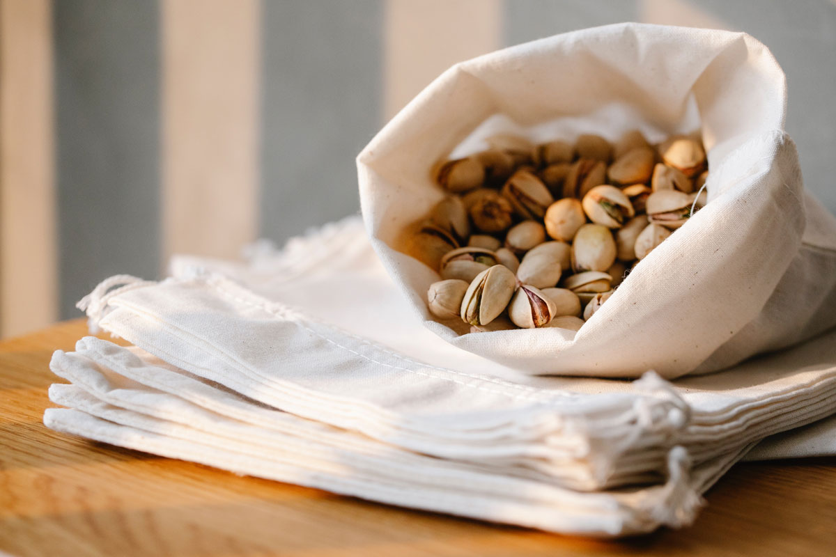 Pistachios wrapped in a napkin on a table